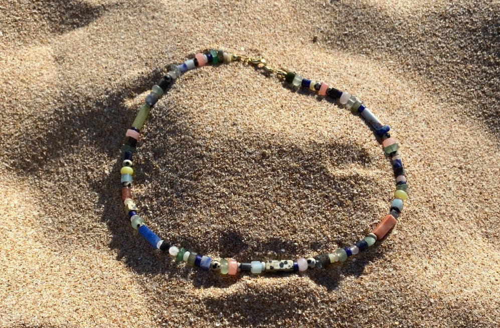 Colourful necklace in the sand